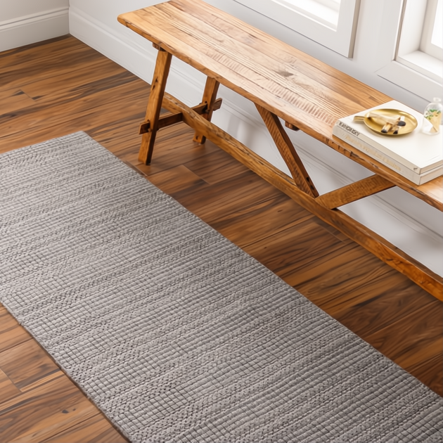 Surya Hickory HCK2304 hand-loomed runner rug in gray, beige, and charcoal, made from recycled PET yarn on wood floor.