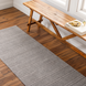 Surya Hickory HCK2304 hand-loomed runner rug in gray, beige, and charcoal, made from recycled PET yarn on wood floor.