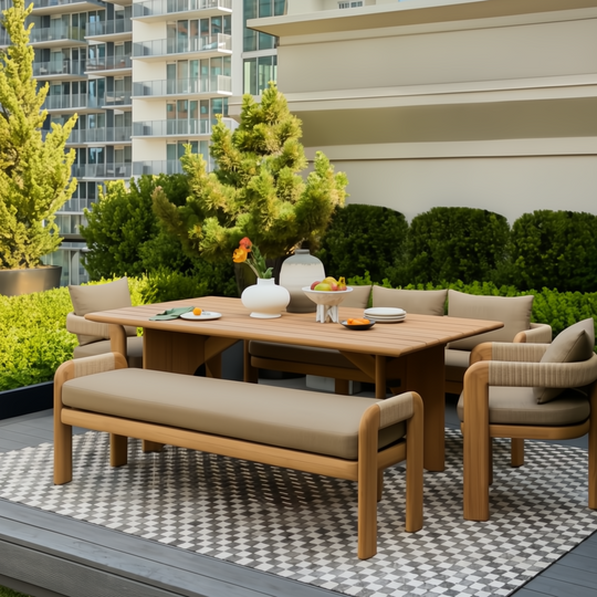Surya Palma outdoor bench with Sunbrella upholstery and teak wood base, part of a dining set on a patio.