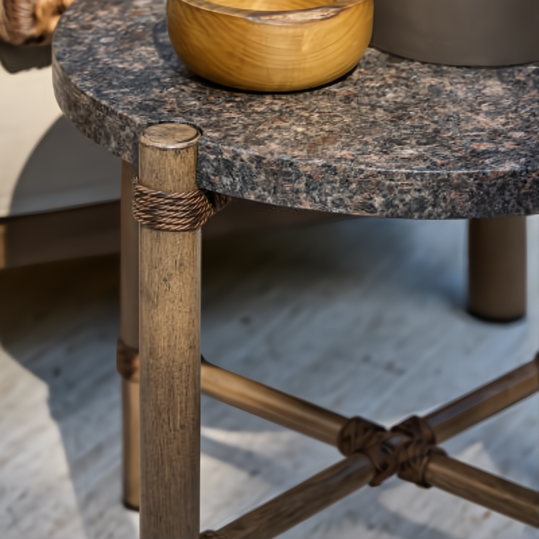 Round Surya Porta outdoor end table with dark brown matte stone top, brown aluminum base, and PE rope detail.