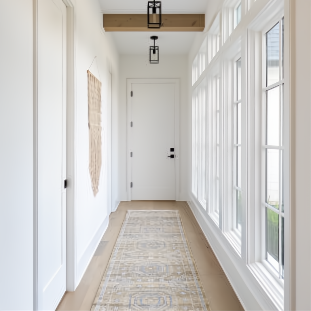 Surya Almeria low pile rug in mustard, gray, blue, beige, cream, and black in a modern hallway.
