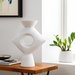 Surya Yagya YAG-007 modern sculptural ceramic vase with a brushed matte white finish and central cutout.