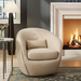 Beige Surya Ariah swivel chair with a lumbar pillow, iron base, and polyester upholstery in a modern living room.