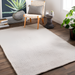 Surya Azalea AZA-2325 hand-woven light gray recycled PET yarn area rug on wood floor.
