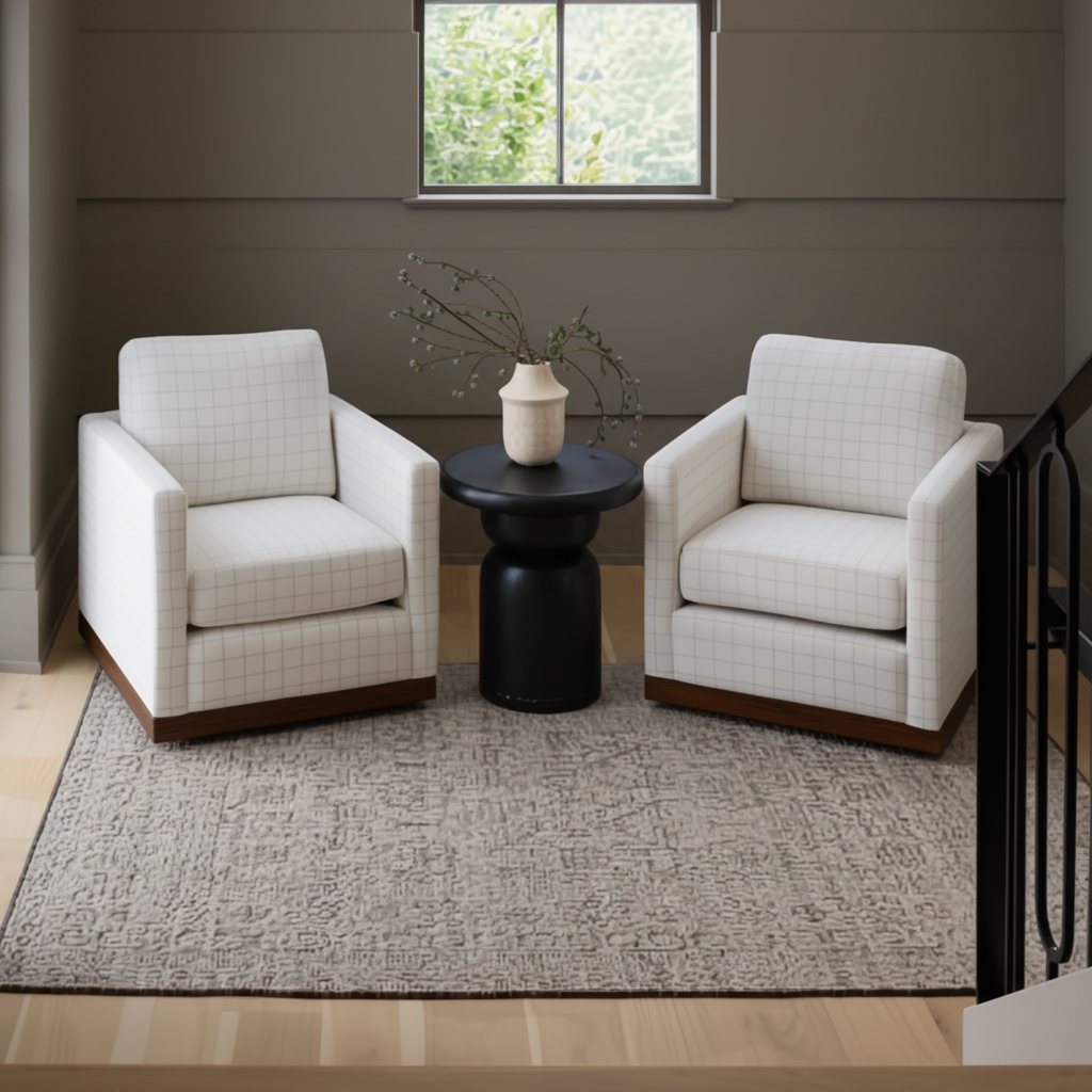Two light beige grid-patterned swivel chairs with brown wood bases flanking a black side table on a rug.