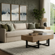 Surya Lowmax coffee table with brown mango wood top and black cast iron base in a living room.