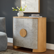 Surya Poros Cabinet with silver gray lacquered cork veneer doors, brown natural oak frame, and round wood handle.
