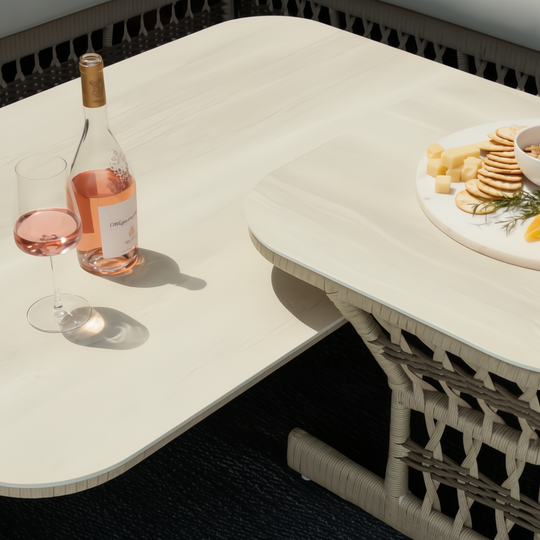 Cream Surya Winder outdoor coffee table with a powder-coated aluminum top and handwoven PE rope detail.