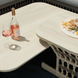 Cream Surya Winder outdoor coffee table with a powder-coated aluminum top and handwoven PE rope detail.