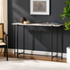 Surya Anaya console table with white natural marble top and black iron base in a modern entryway.
