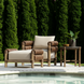 Brown wicker and aluminum Surya Porta outdoor accent chair with Sunbrella cushion by a pool.