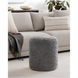 Gray Surya Mohave pouf with a textured, sheepskin-like polyester top, perfect as a footrest or accent piece.