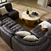 Black 100% leather Surya Oryan modular sofa with tufted cushions, arranged around a round coffee table.