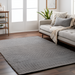 Surya Azalea AZA-2316 hand-woven gray recycled PET yarn rug with a minimalist ribbed design in a living room.