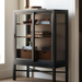 Surya Marin 55" black and brown bookcase with glass doors, wood shelves, and lower drawers.