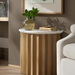 Surya Piestra end table with white marble top, brown fluted mango wood base, and demilune shape.