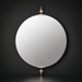 Round mirror with brass accents on a dark wall.