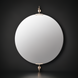 Round mirror with brass accents on a dark wall.