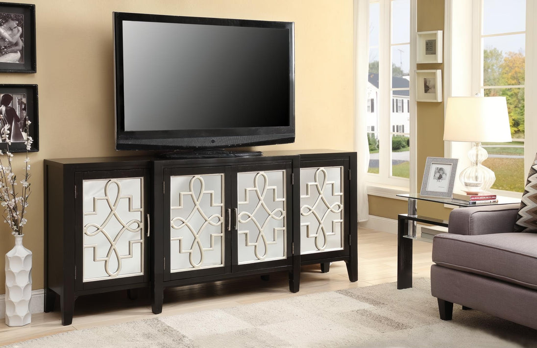 Antique black console table with four doors featuring decorative white geometric overlays, holding a TV.