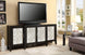 Antique black console table with four doors featuring decorative white geometric overlays, holding a TV.