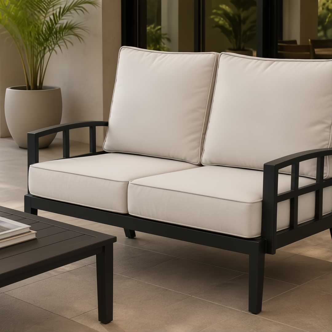 Surya Fairborn Loveseat: Black aluminum frame outdoor sofa with light beige acrylic cushions.