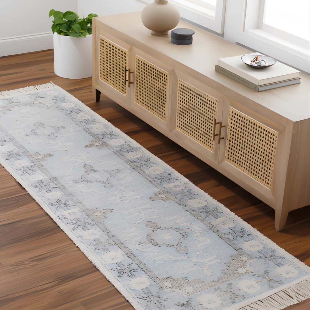 Light blue Surya Bursa runner rug with subtle floral patterns and fringe, made from recycled PET yarn.