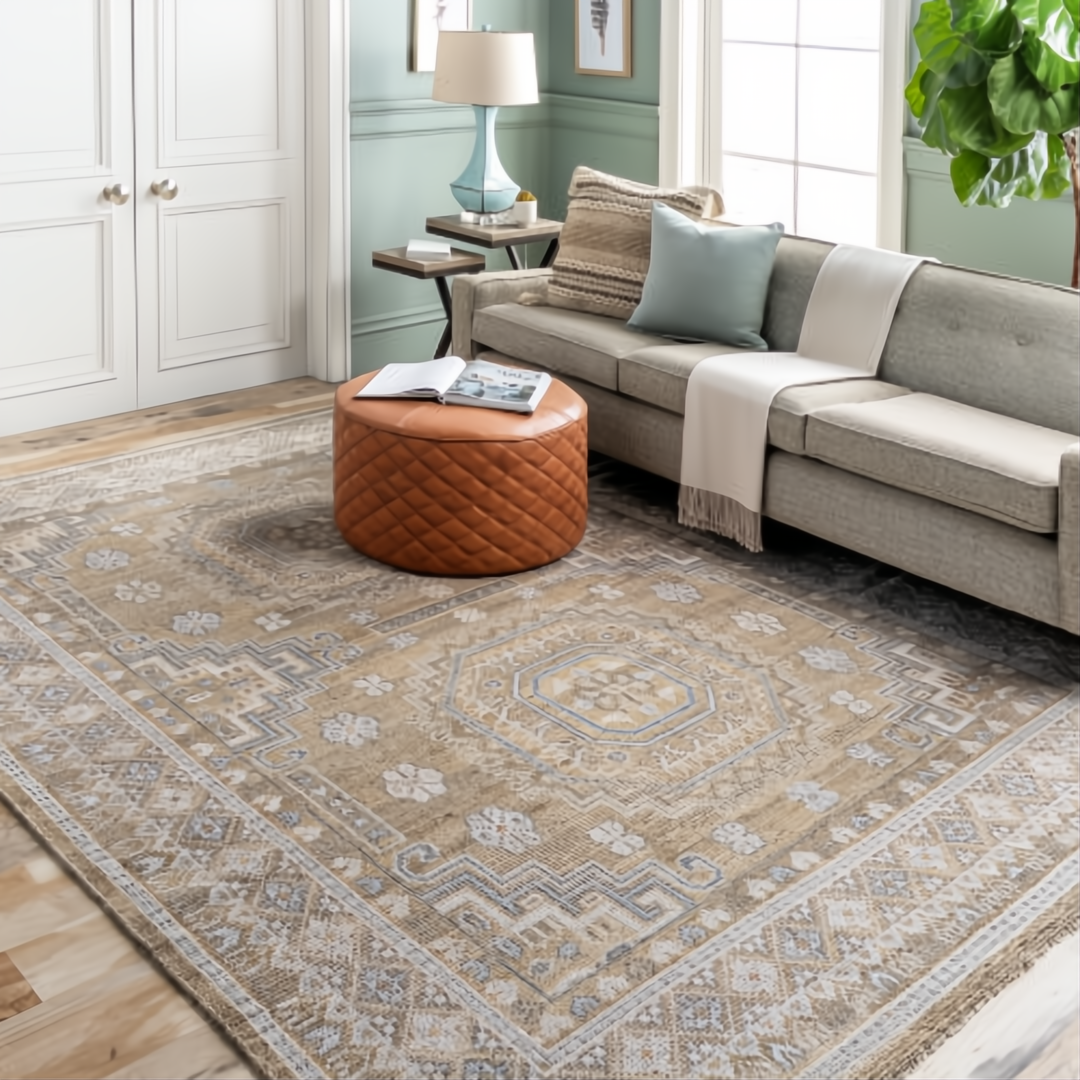 Surya Almeria low pile rug with mustard, gray, pale blue, and beige geometric patterns in a living room.