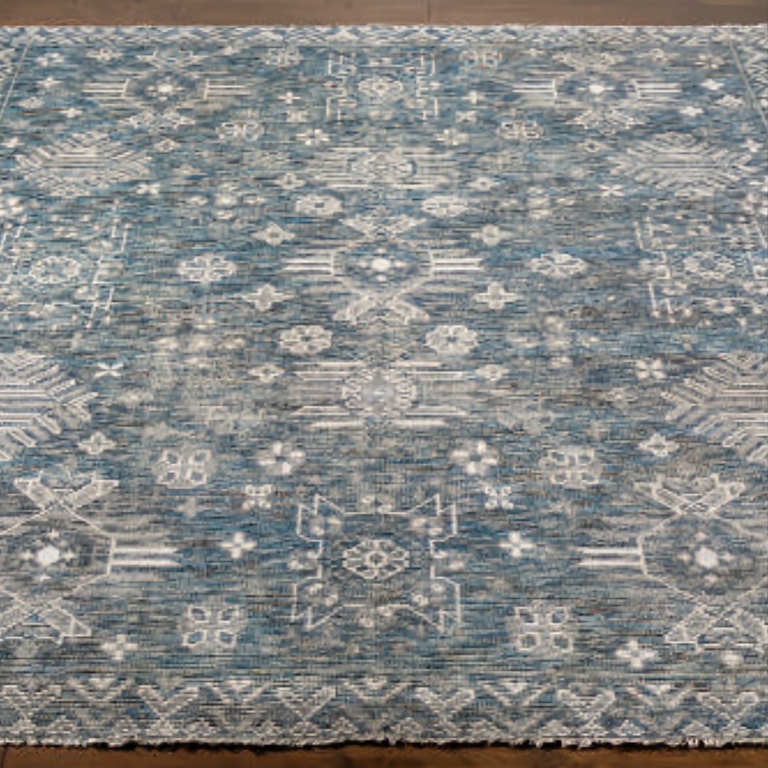 Hand-knotted Surya Almeria rug with a low pile, featuring a distressed teal, gray, and white geometric pattern.