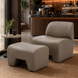 Surya Sable Accent Chair and matching ottoman in taupe, mocha, sandstone, with cushioned seating on a rug.