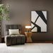 Surya Aasmaa AAM-001 modern abstract black and white wall art above a brown armchair.