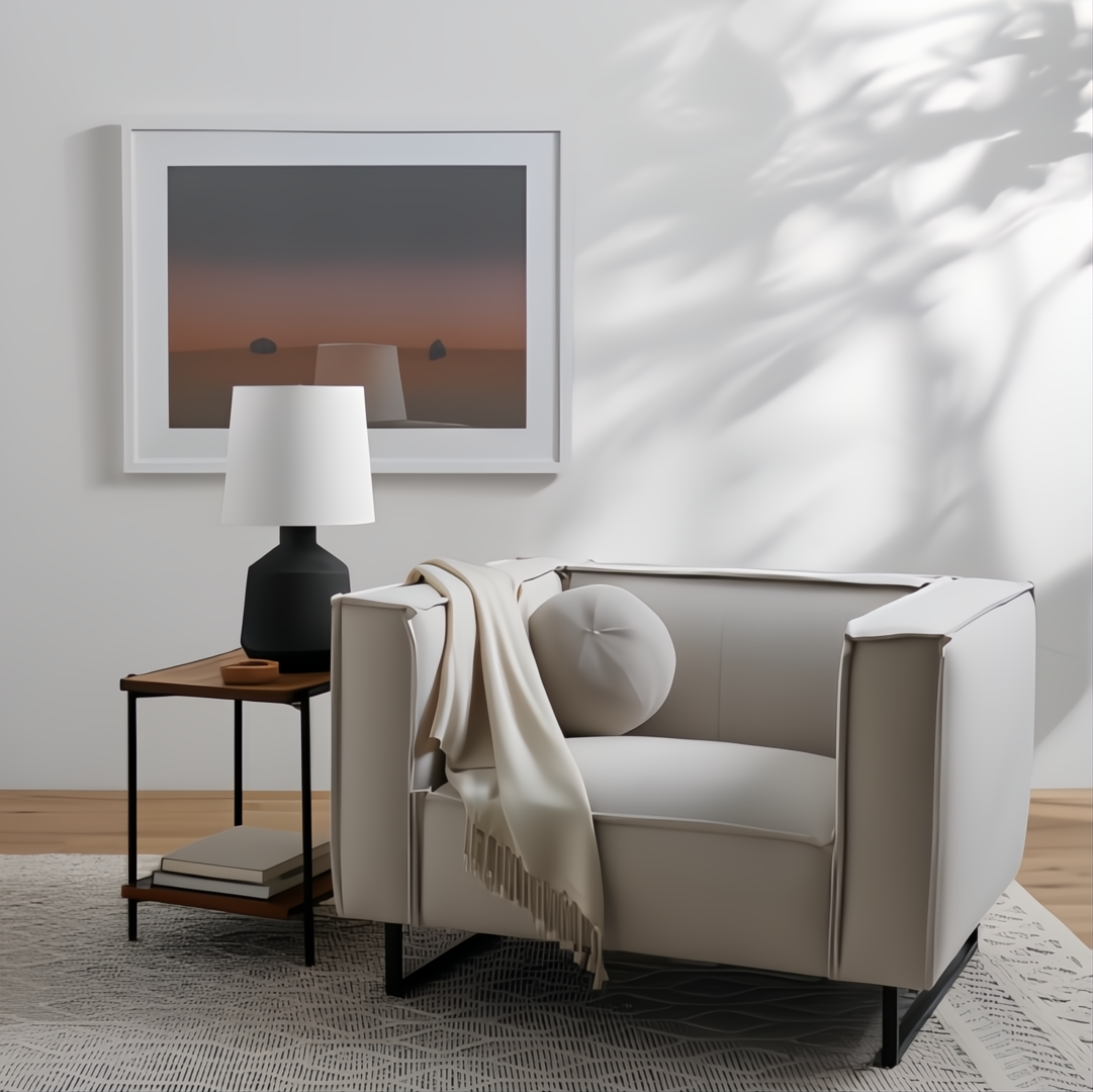 Modern light gray linen accent chair with black iron base, throw blanket, and round pillow.