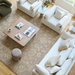 Overhead view of a living room with a white Surya Capitola accent chair, sofa, and rug.