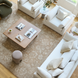Overhead view of a living room with a white Surya Capitola accent chair, sofa, and rug.