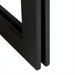 Close-up of the black cast iron base of the Surya Lowmax Coffee Table, showing its minimalist design.