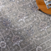 Surya Almeria low pile area rug in medium gray, gray, and cream with floral patterns.