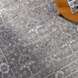 Surya Almeria low pile area rug in medium gray, gray, and cream with floral patterns.