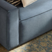 Surya Aira contemporary navy polyester sofa with clean lines and a subtle texture, on a patterned rug.
