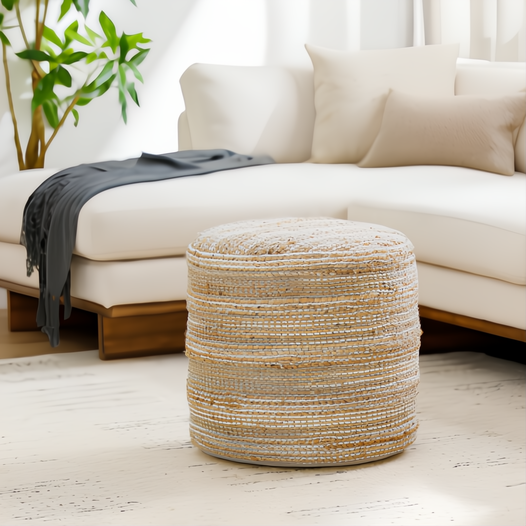 Camel jute and cotton Surya Denpasar pouf with woven texture and raw edge detail in a living room.