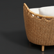 Close-up of a natural wicker sofa with a curved back and white cushions, suitable for indoor or outdoor use.