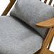Close-up of a Surya Acworth accent chair with medium gray polypropylene cushions and light brown wooden arms.