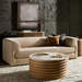 Beige polished marble top Surya Redondo coffee table with ribbed mango wood base in a modern living room.