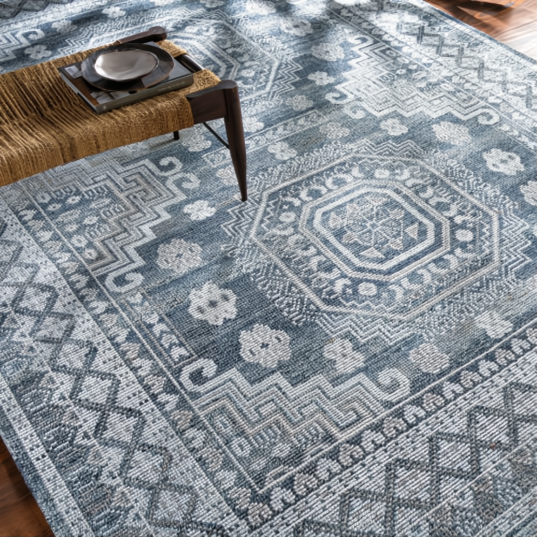 Hand-knotted Surya Almeria low pile area rug in black, gray, beige, and pale blue with geometric patterns.