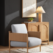 Light blue Surya Brielle accent chair with a woven ash wood frame and brown base.
