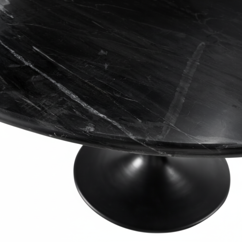 Close-up of a round Surya Anatalia dining table with a black polished marble top and black iron base.