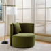 Modern black and gold sculptural floor lamp with an ivory linen shade next to a green velvet accent chair.