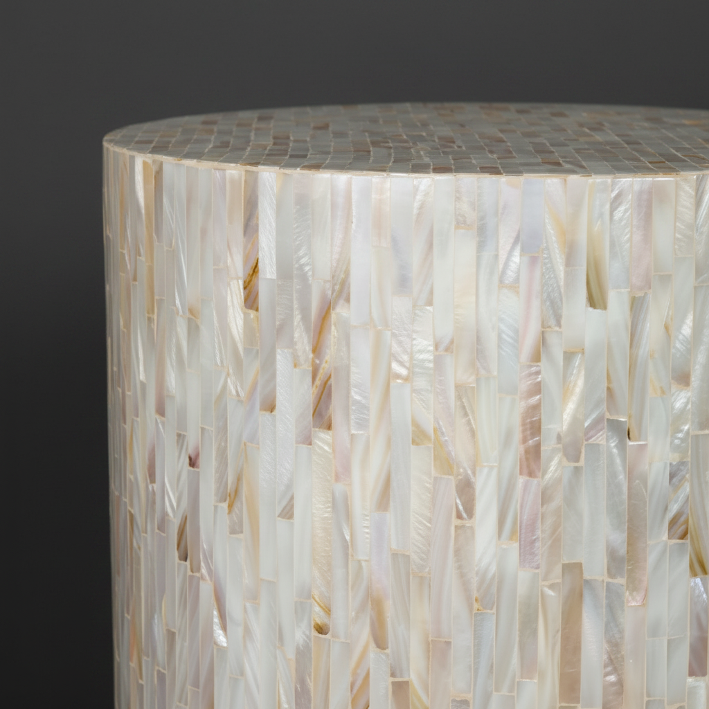 Round Surya Iridescent End Table with tan and ivory shell detailing, crafted from shell and manufactured wood.
