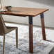 Surya Billings Dining Table with dark brown oak veneer top, rubber wood legs, and black metal accents.