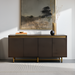 Scandinavian modern sideboard with brown oak veneer top, metallic brass frame, and four soft-close doors.