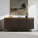 Scandinavian modern sideboard with brown oak veneer top, metallic brass frame, and four soft-close doors.