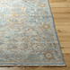 Hand-knotted Surya Cappadocia wool rug in pale blue, gray, taupe, and brown with traditional patterns and fringe.